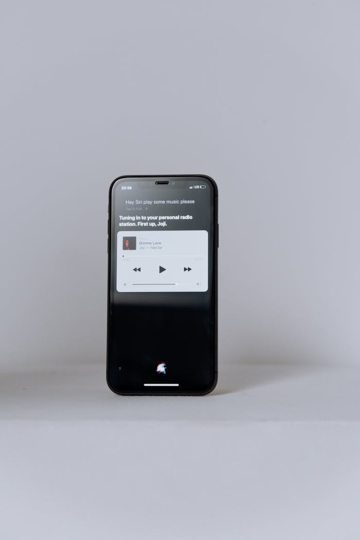 A smartphone showcasing a music app on a clean, minimalist background - ideal for technology themes.